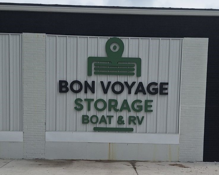 Bon Voyage Storage Logo and sign on building next to gate entrance